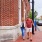 a couple walk in the neighborhood brick-laden streets