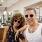 a couple pose with sunglasses on while in a retail environment
