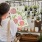 lifestyle image of a person holding up art prints of floral designs