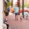 a man walking wit his dog in the nearby downtown environment